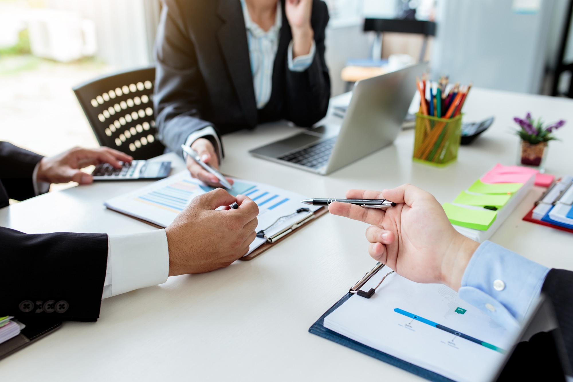 Teamwork process, business people working in the office discussing documents and ideas at meeting.